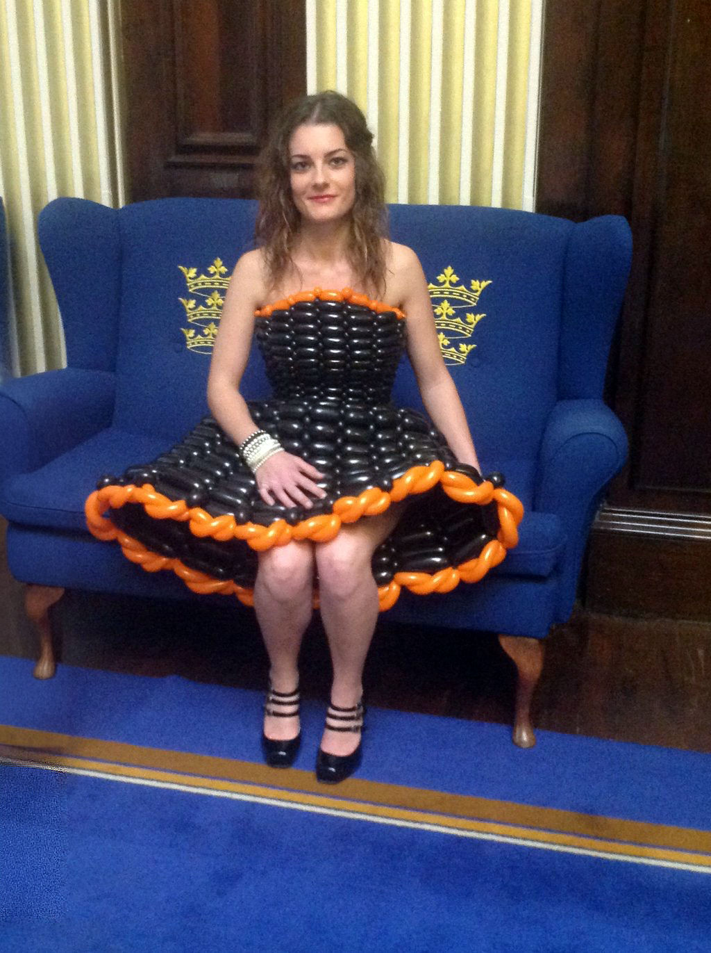 Model seated comfortably in a balloon dress